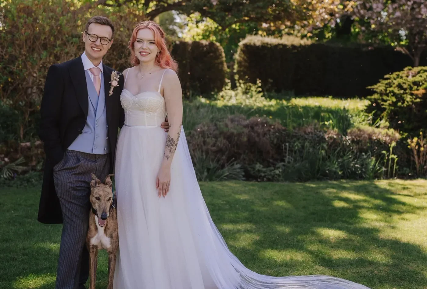 Kronk the dog with his couple on their wedding day